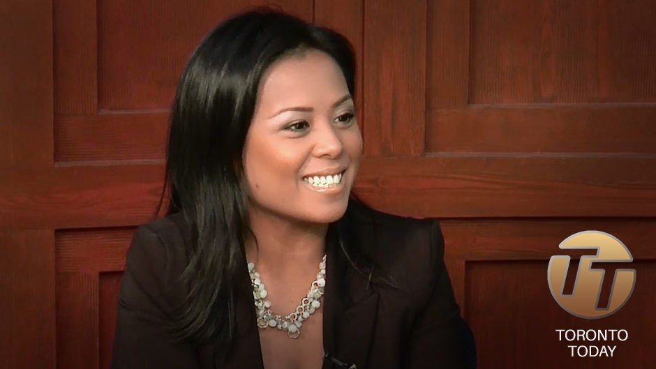 A person doing an interview with a red wall in the background.